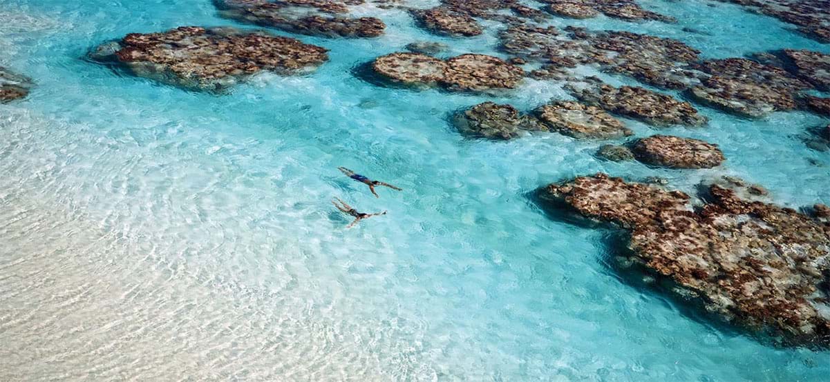 Couple snorkeling in French Polynesia