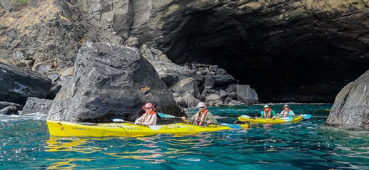 View of travelers kayaking in Santiago during luxury family vacation, Galapagos Islands, Ecuador