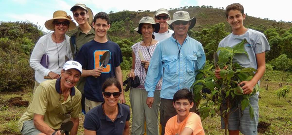 View of the Pesky family planting trees and giving back to the community during luxury family vacation to the Galapagos Islands, Ecuador 