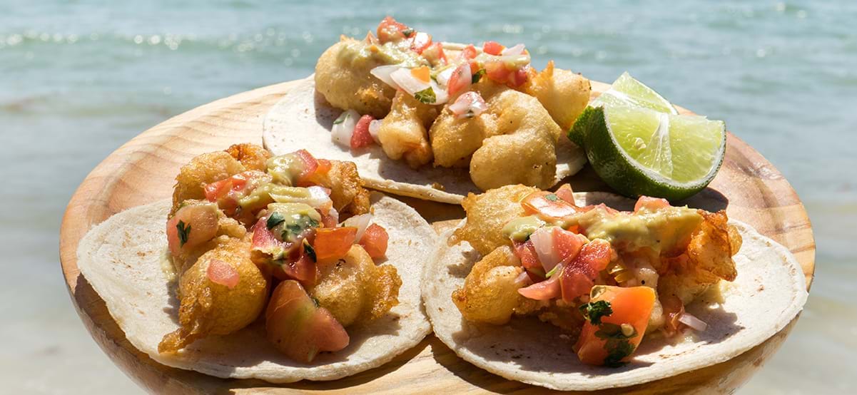 Shrimp tacos garnished with lime, luxury destination Tulum, Mexico