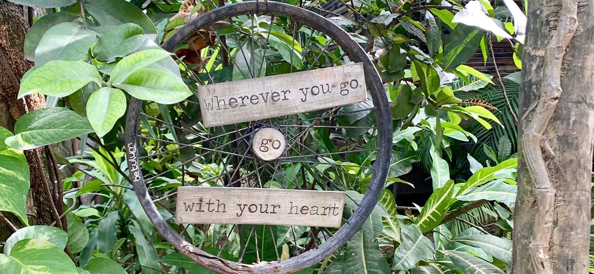 Resort sign saying Whever you go go with your heart, luxury destination Tulum, Mexico