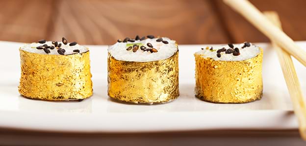 Edible gold on sushi rolls luxury culinary vacation