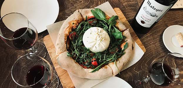 Gourmet Italian meal with burrata and red wine